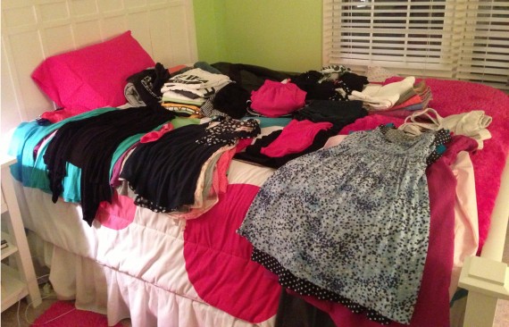 Clothes laid out on bed while packing!