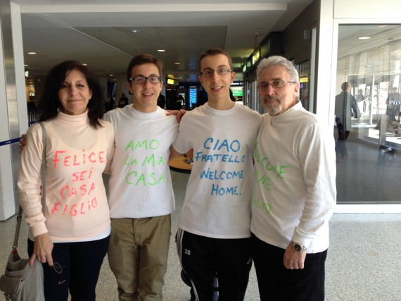 My family welcoming me home from Italy is our custom made shirts!